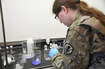 Maj. Shannon Quevedo, assistant professor in the chemistry department at 鶹ŮԱ Institute, examines hydrogels in researching ways to detect contaminates in water. -VMI Photo by Marianne Hause.