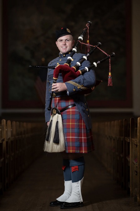 Dakota Birdsong ’24, a cadet at 鶹ŮԱ Institute, poses with his bagpipe and VMI Pipe Band uniform, which includes a tartan.