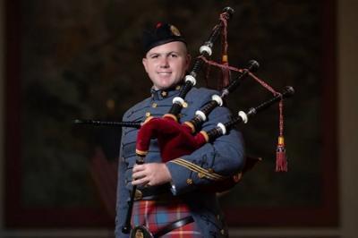 Dakota Birdsong ’24, a cadet at 鶹ŮԱ Institute, poses with his bagpipe and VMI Pipe Band uniform, which includes a tartan.